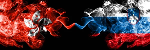 Hong Kong, China vs Slovenia, Slovenian smoky mystic states flags placed side by side. Concept and idea thick colored silky abstract smoke flags