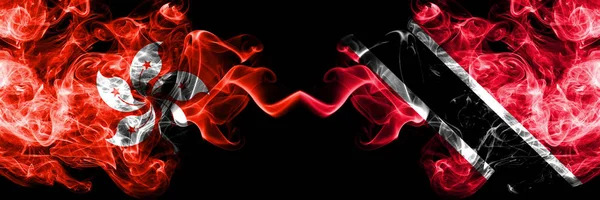 Hong Kong, China vs Trinidad and Tobago smoky mystic states flags placed side by side. Concept and idea thick colored silky abstract smoke flags — Stock Photo, Image