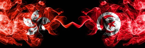 Hong Kong, China vs Tunisia, Tunisian smoky mystic states flags placed side by side. Concept and idea thick colored silky abstract smoke flags — Stock Photo, Image