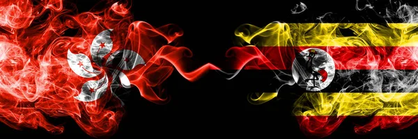 Hong Kong, China vs Uganda, Ugandan smoky mystic states flags placed side by side. Concept and idea thick colored silky abstract smoke flags — Stock Photo, Image