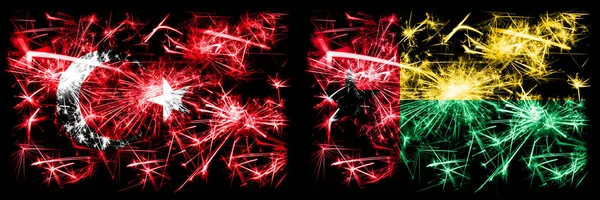 トルコ、トルコ対ギニアビサウ新年のお祝い輝く花火の旗の概念の背景。2つの抽象的な状態フラグの組み合わせ. — ストック写真