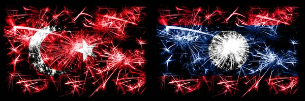 Türkei, türkisch vs laos Neujahrsfeier funkelnden Feuerwerk Flaggen Konzept Hintergrund. Kombination aus zwei abstrakten Staaten Flaggen. — Stockfoto