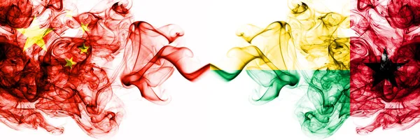 China, Chinese vs Guinea Bissau smoky mystic states flags placed side by side. Concept and idea thick colored silky abstract smoke flags — Stock Photo, Image