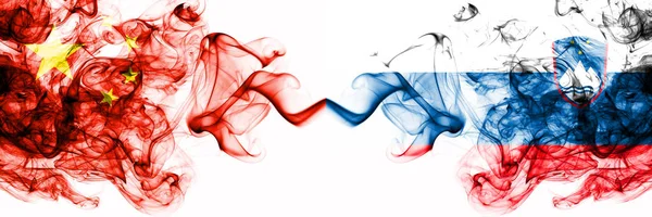 China, Chinese vs Slovenia, Slovenian smoky mystic states flags placed side by side. Concept and idea thick colored silky abstract smoke flags — ストック写真