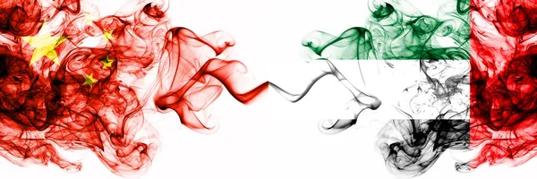 China, Chinese vs United Arab Emirates, Emirati smoky mystic states flags placed side by side. Concept and idea thick colored silky abstract smoke flags