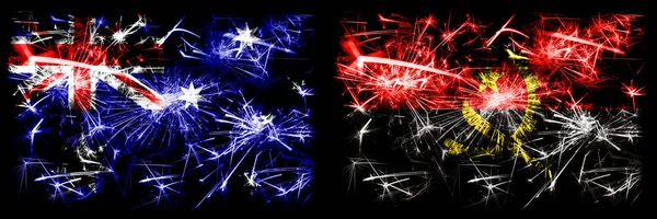 Austrálie, Ozzie vs Angola, Angolský Nový rok oslavy jiskřící ohňostroje vlajky koncept pozadí. Kombinace dvou abstraktních stavových příznaků. — Stock fotografie