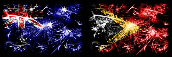 Australien, Ozzie vs East Timor Neujahrsfeier funkelnden Feuerwerk Flaggen Konzept Hintergrund. Kombination aus zwei abstrakten Staaten Flaggen. — Stockfoto