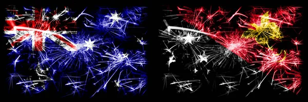 Australien, Ozzie vs Papua Neuguinea Silvesterfeier funkelnden Feuerwerk Flaggen Konzept Hintergrund. Kombination aus zwei abstrakten Staaten Flaggen. — Stockfoto
