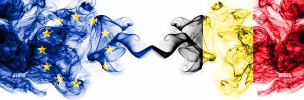 Eu, Europese Unie vs België, Belgische rokerige mystieke vlaggen naast elkaar geplaatst. Dikke gekleurde zijdeachtige abstracte rookvlaggen combinatie — Stockfoto