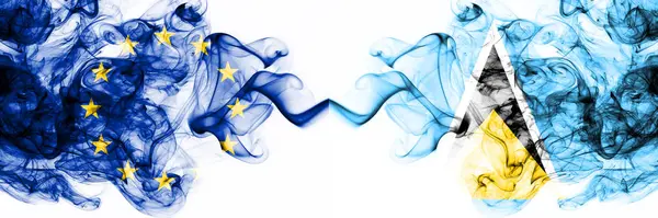 Europa, Europeiska unionen mot Saint Lucia rökiga mystiska flaggor placerade sida vid sida. Tjock färgad silkeslen abstrakt rök flaggor kombination — Stockfoto