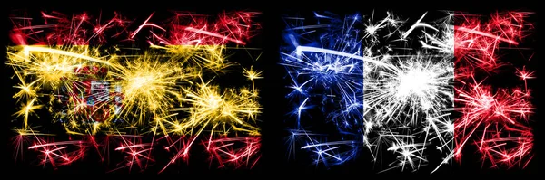 Spanish vs France, French New Year celebration sparkling fireworks flags concept background. Combination of two abstract states flags. — Stock Photo, Image