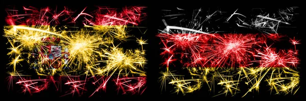 Испанский против Германии, немецкий Новый год праздник сверкающий фейерверк флаги концепция фона. Сочетание двух абстрактных флагов состояний . — стоковое фото