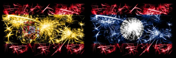 Espanhol vs Laos celebração de Ano Novo fogos de artifício cintilantes fundo conceito bandeiras. Combinação de duas bandeiras de estados abstratos . — Fotografia de Stock