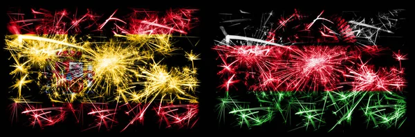 Spanisch vs Malawi, malawische Neujahrsfeier funkelnden Feuerwerk Flaggen Konzept Hintergrund. Kombination aus zwei abstrakten Staaten Flaggen. — Stockfoto