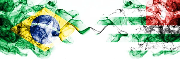 Brazylia, Brazylijczyk vs Abchazja, Abchazjańskie flagi mistyczne umieszczone obok siebie. Grube kolorowe jedwabiste abstrakcyjne połączenie flag dymu — Zdjęcie stockowe