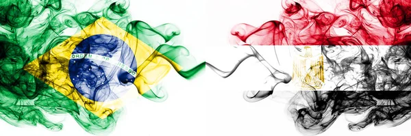Brazil, Brazilian vs Egypt, Egyptian smoky mystic flags placed side by side. Thick colored silky abstract smoke flags combination — Stock Photo, Image