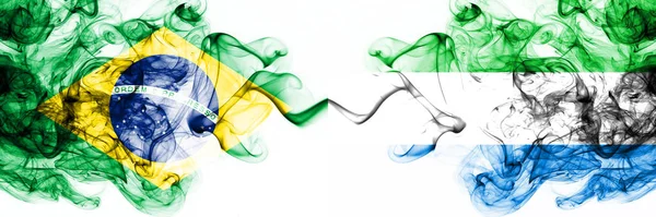 Brazil, Brazilian vs Sierra Leone smoky mystic flags placed side by side. Thick colored silky abstract smoke flags combination