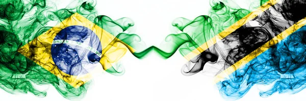 Brazylia, Brazylijczyk vs Tanzania, Tanzańskie smoky mistyczne flagi umieszczone obok siebie. Grube kolorowe jedwabiste abstrakcyjne połączenie flag dymu — Zdjęcie stockowe