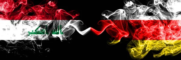 伊拉克 伊拉克对南奥塞梯烟熏神秘的旗帜肩并肩地放置在一起 浓密的彩色丝质烟旗连在一起 — 图库照片