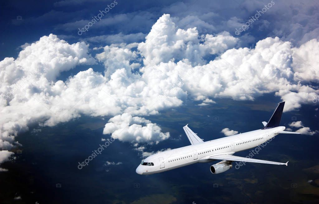 Passenger plane in the sky among the clouds. The concept of holidays and travel. Air transport travel