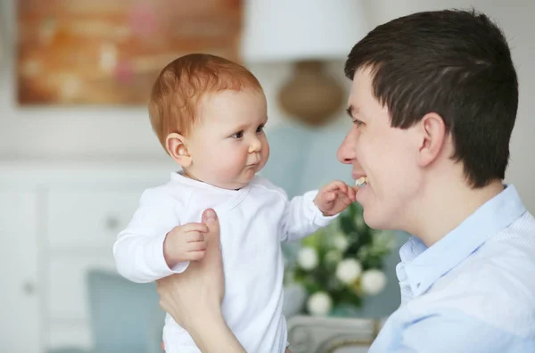 Un padre feliz con un bebé adorable en el dormitorio. Papi e hija — Foto de Stock