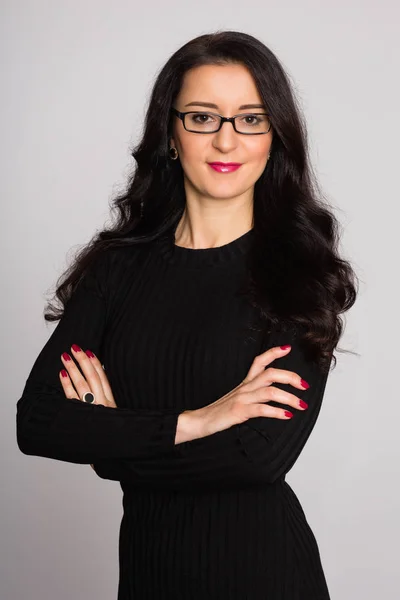 Young woman with black hair on a background of wall — Stock Photo, Image