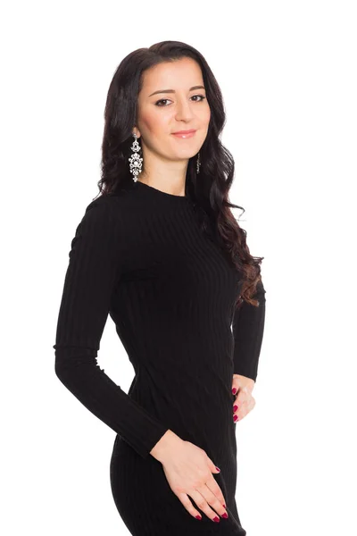 Charmante brunette meisje in een zwarte jurk geïsoleerd op wit — Stockfoto