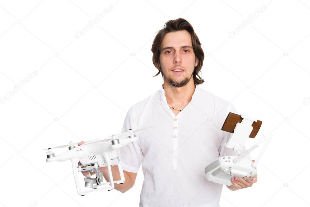 Young man holding a flying drone and remote control