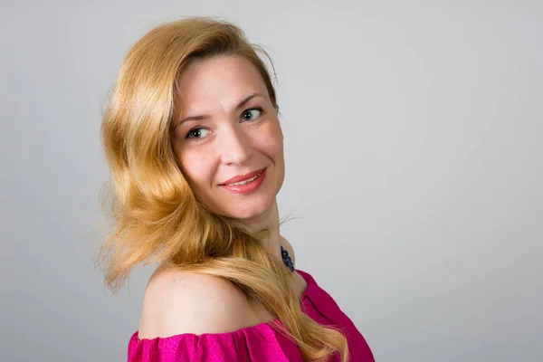 Portrait of a 39 year old woman in pink dress — Stock Photo, Image