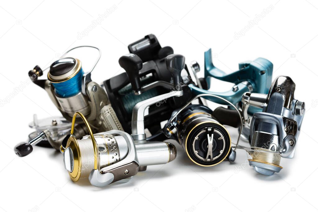 Different fishing reels isolated on white