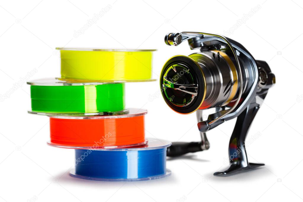 Multi-colored monofilament fishing line and fishing reel isolated on white