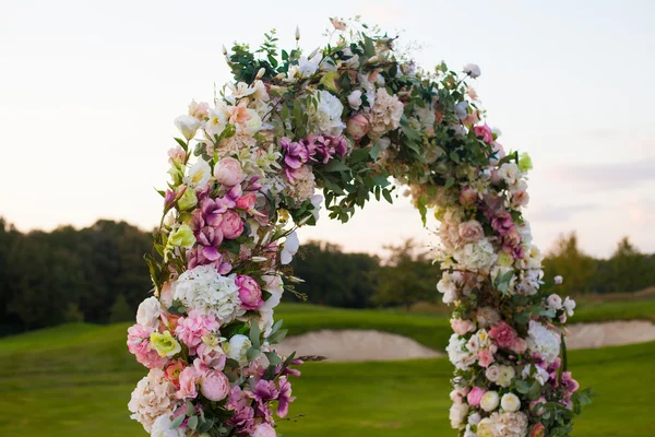 Arco floreale sul campo verde — Foto Stock