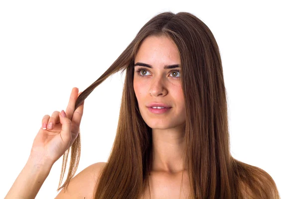 Mulher segurando um fio de cabelo — Fotografia de Stock
