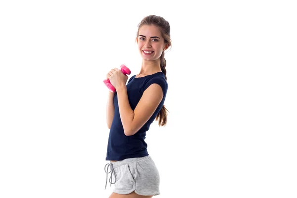 Smiling woman holding two dumbbells — Stock Photo, Image