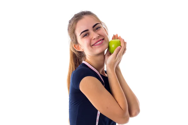 Woman with centimeter holding an apple — Stock Photo, Image