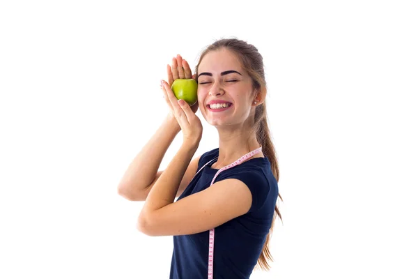 Woman with centimeter holding an apple — Stock Photo, Image