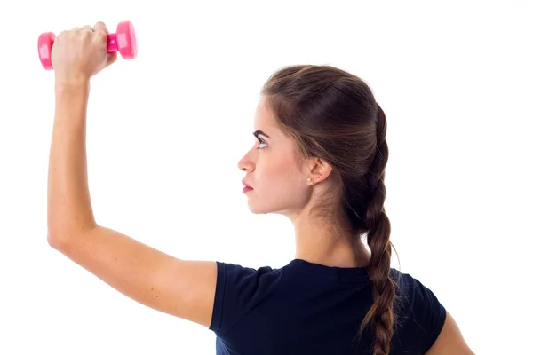 Woman holding a pink dumbbell — ストック写真