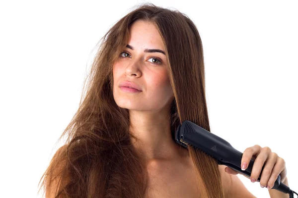 Mujer usando plancha de pelo — Foto de Stock