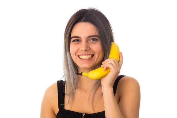 Mulher fazendo um telefone de banana — Fotografia de Stock