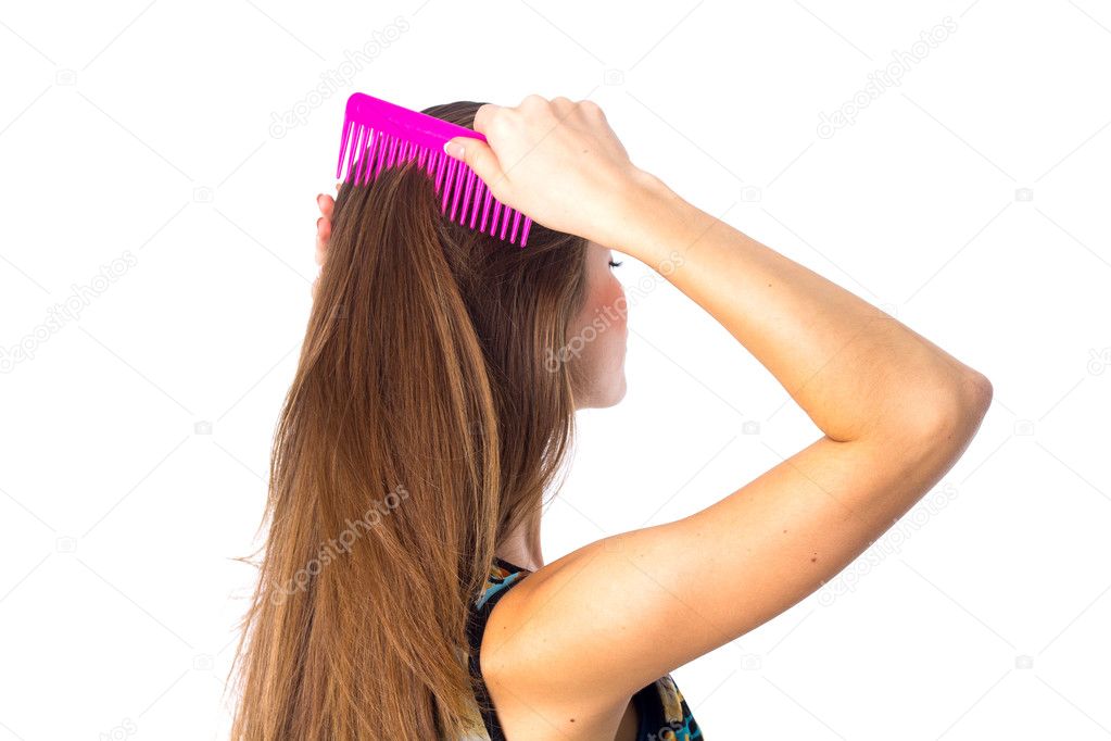Young woman brushing her long hair