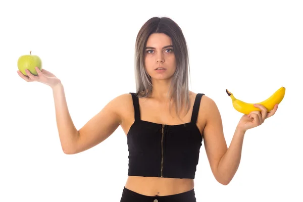 Woman holding apple and banana — Stock Photo, Image