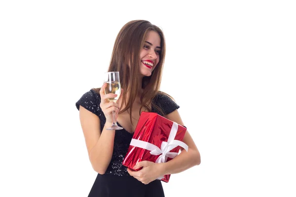 Young woman holding a present and a glass of champagne — Stock Photo, Image