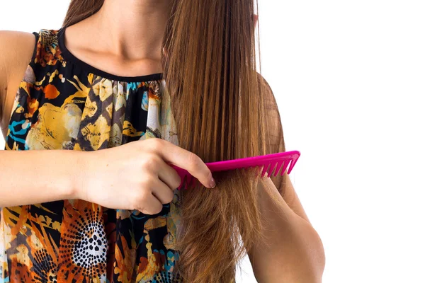 Молода жінка чистить довге волосся — стокове фото