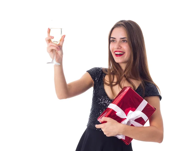 Young woman holding a present and a glass of champagne Stock Image