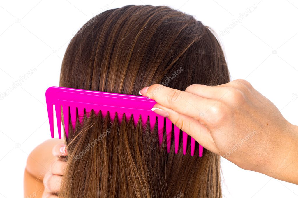 Young woman brushing her long hair