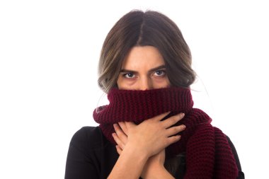 Woman hiding her face with long scarf