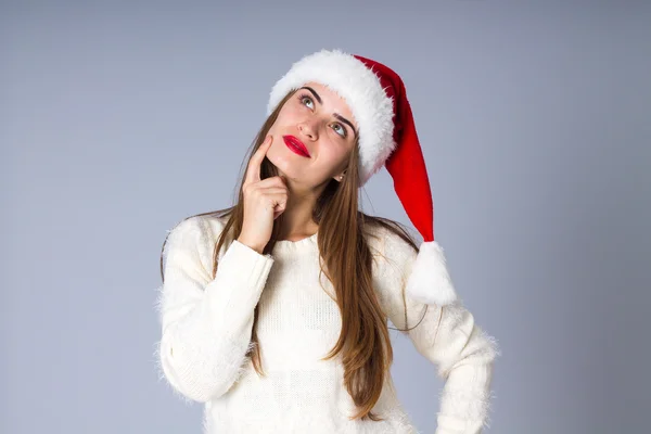 Woman in red christmas hat looking up — Stock Fotó