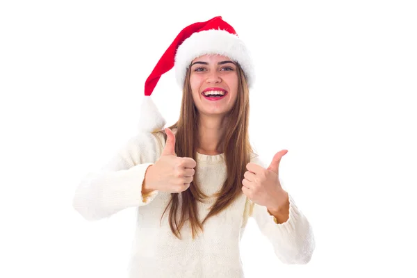 Woman in red christmas hat showing thumbs up — Stockfoto