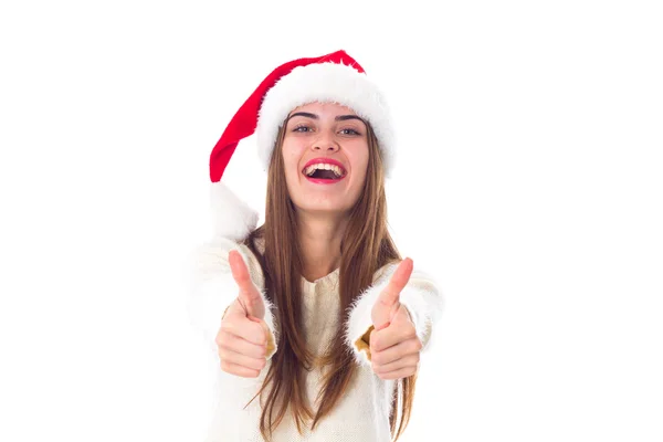 Woman in red christmas hat showing thumbs up — Zdjęcie stockowe