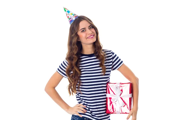 Woman in celebration cap holding a present — Stock Photo, Image